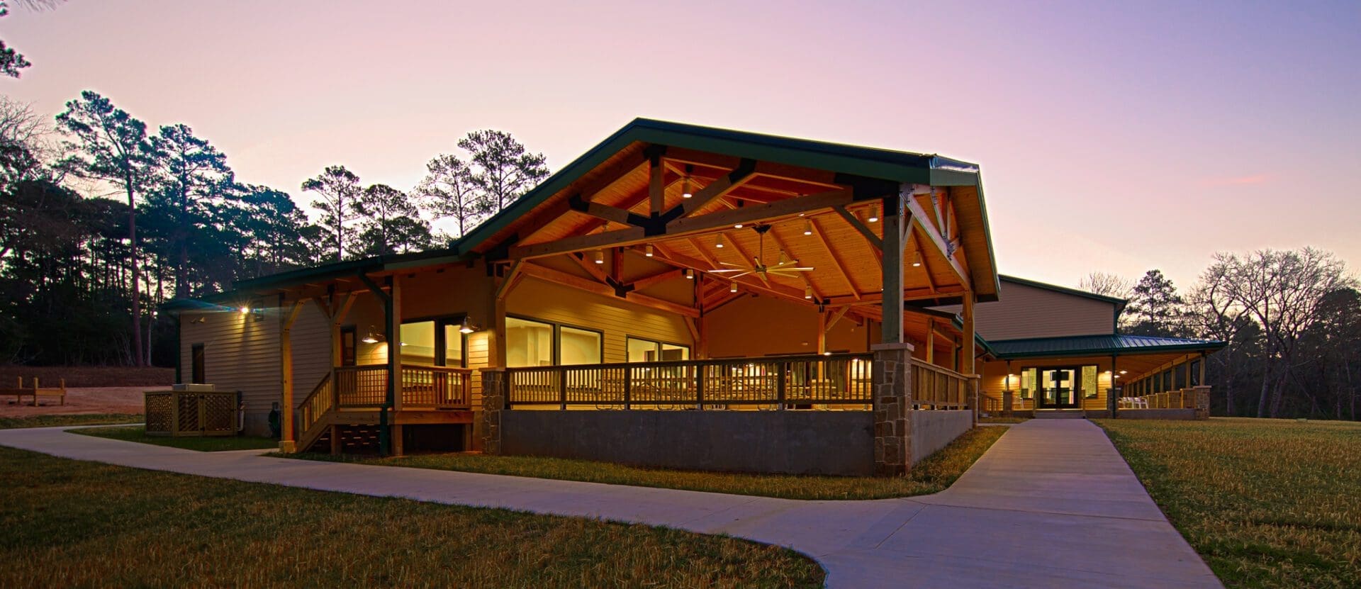 Modern building with wooden beams at sunset.
