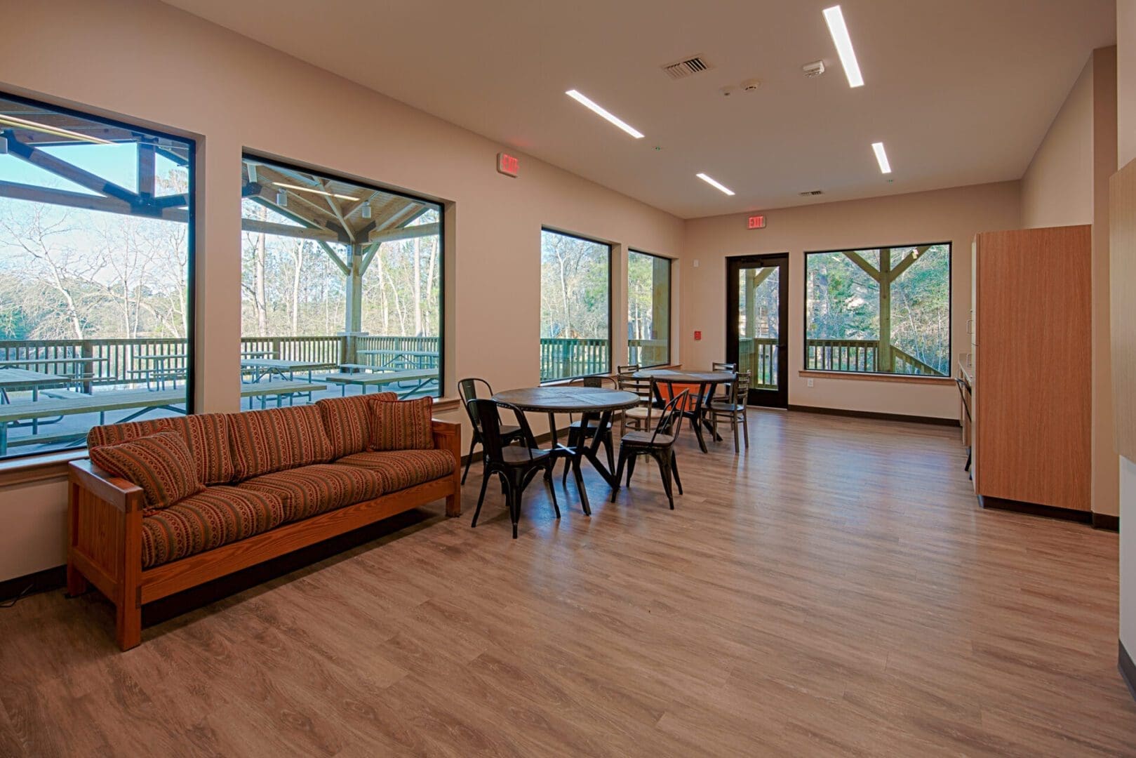 Community room with seating and large windows.