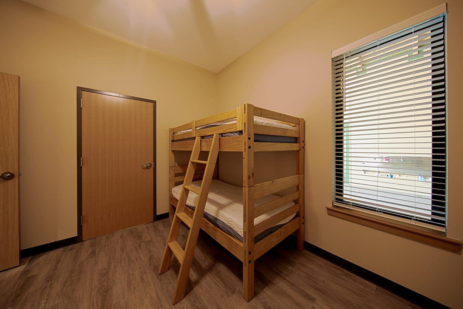 Simple room with wooden bunk bed.