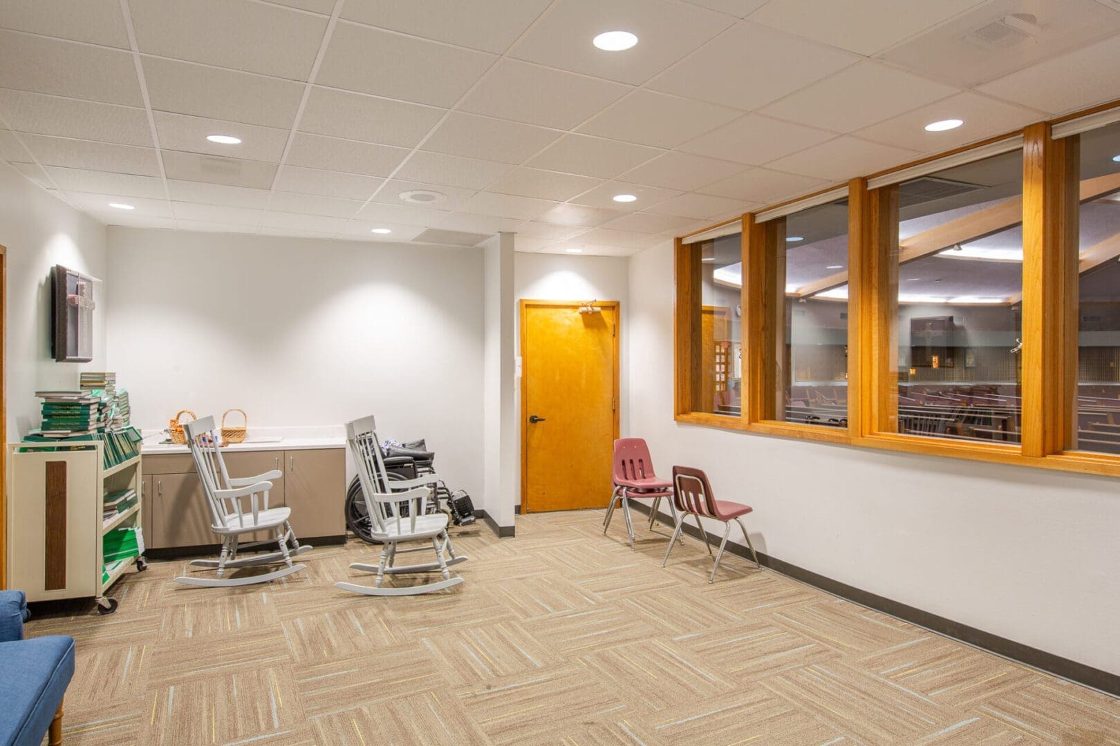 Room with chairs and large windows.