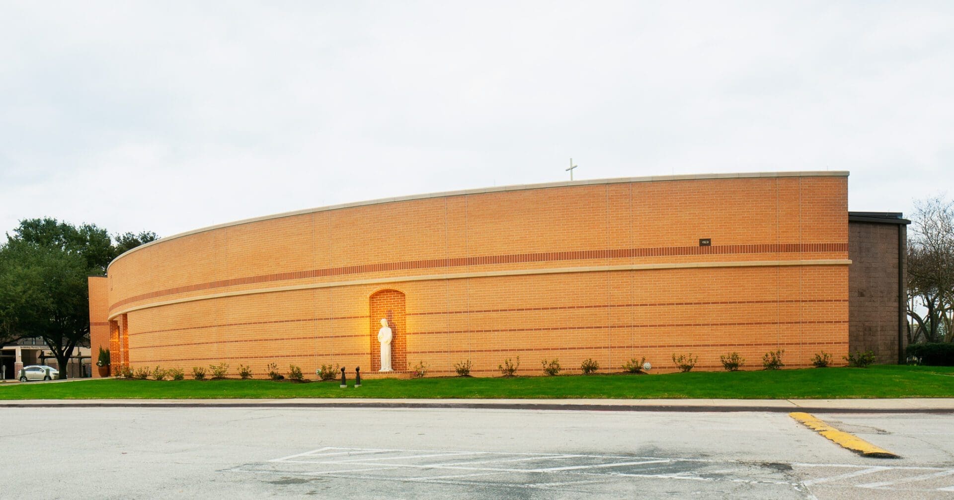Modern brick building with a curved design.