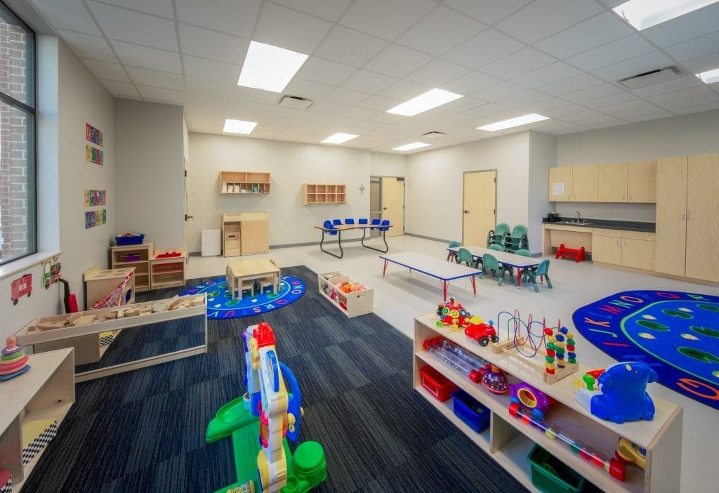 Colorful preschool classroom with toys and tables.