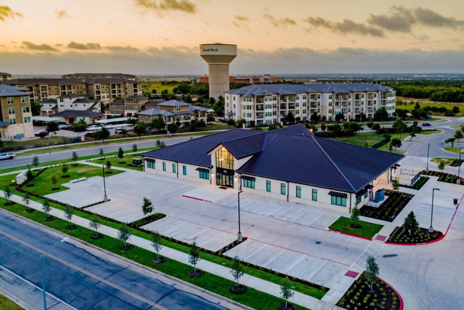 Aerial view of suburban buildings and water tower.