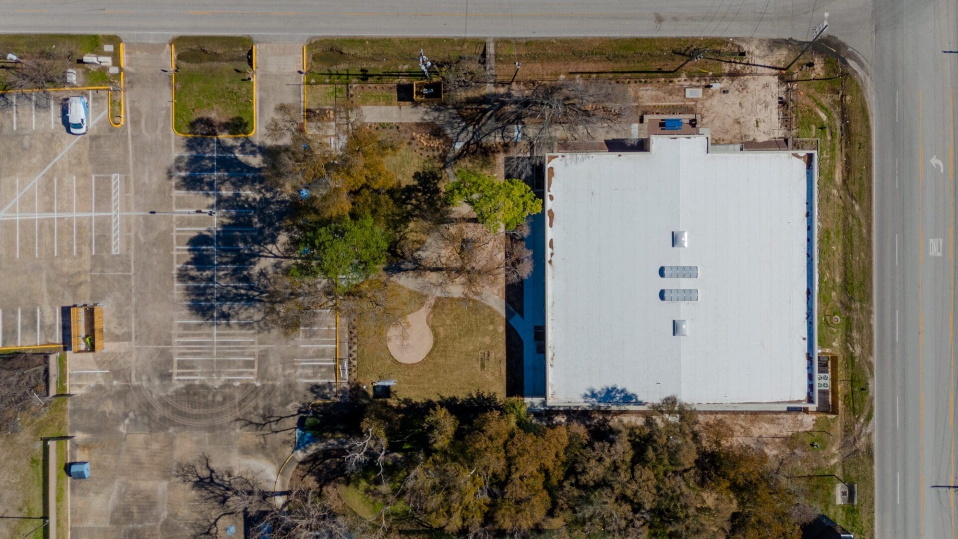 Aerial view of building with parking lot.