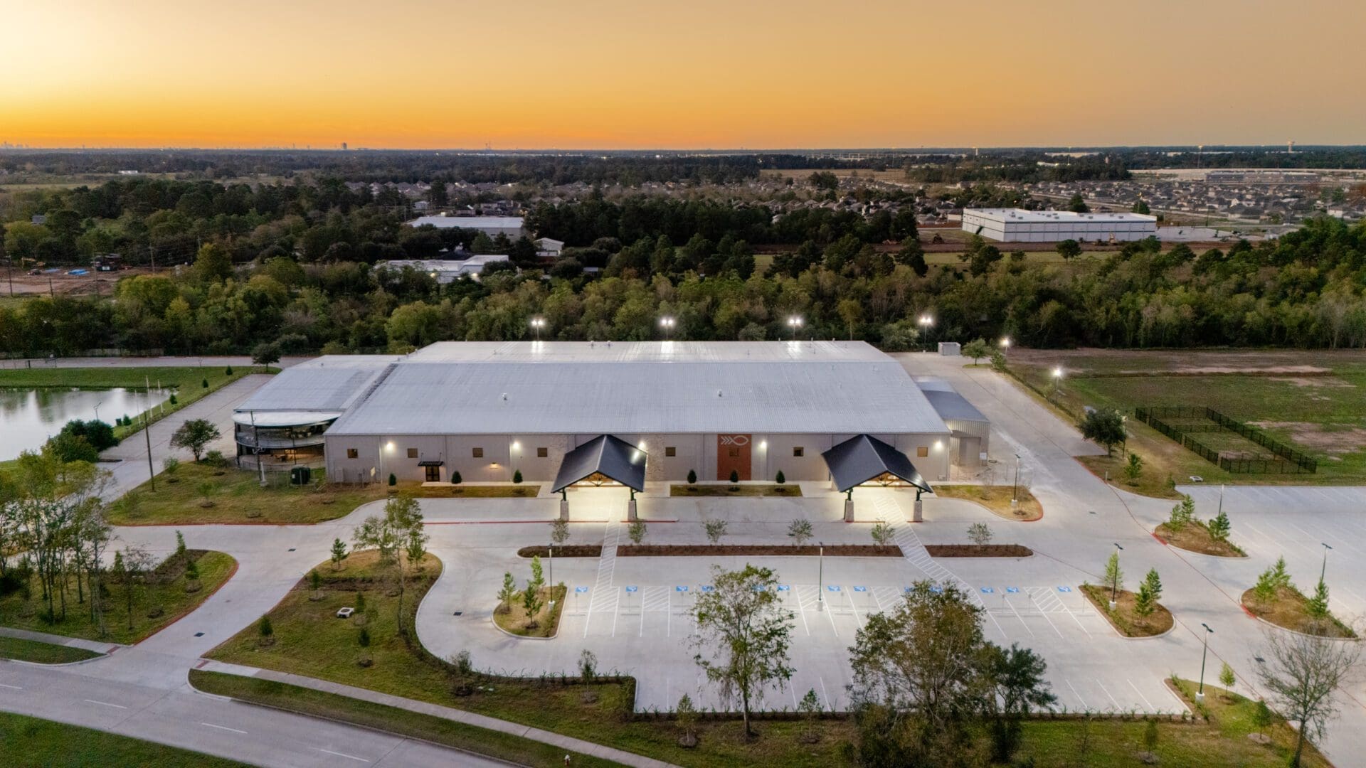 Aerial view of large building at sunset.